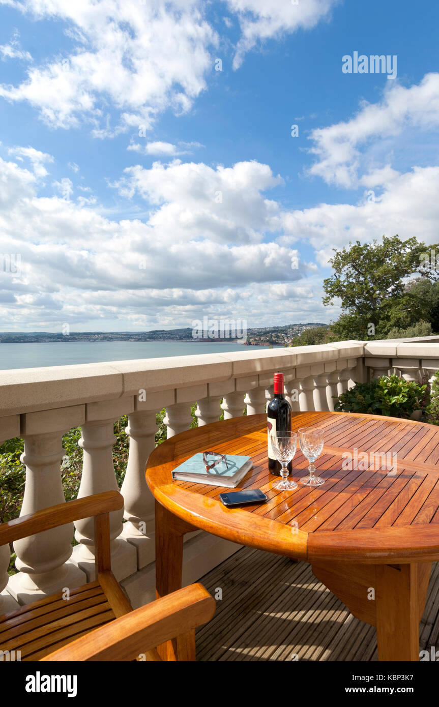 A tbottle of red wine two glasses awaits the owners of this apartment with a stunning view of Tor Bay in Torquay, Devon. Stock Photo