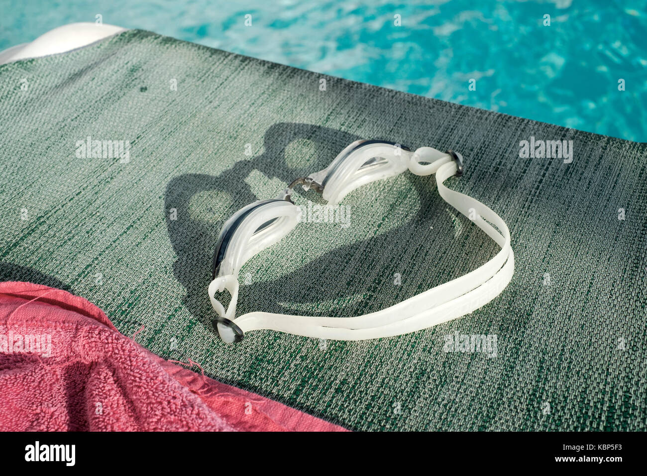 Pair of swimming goggles left on a sun lounger by a pool at Hotel Ninays in Lloret de Mar Stock Photo