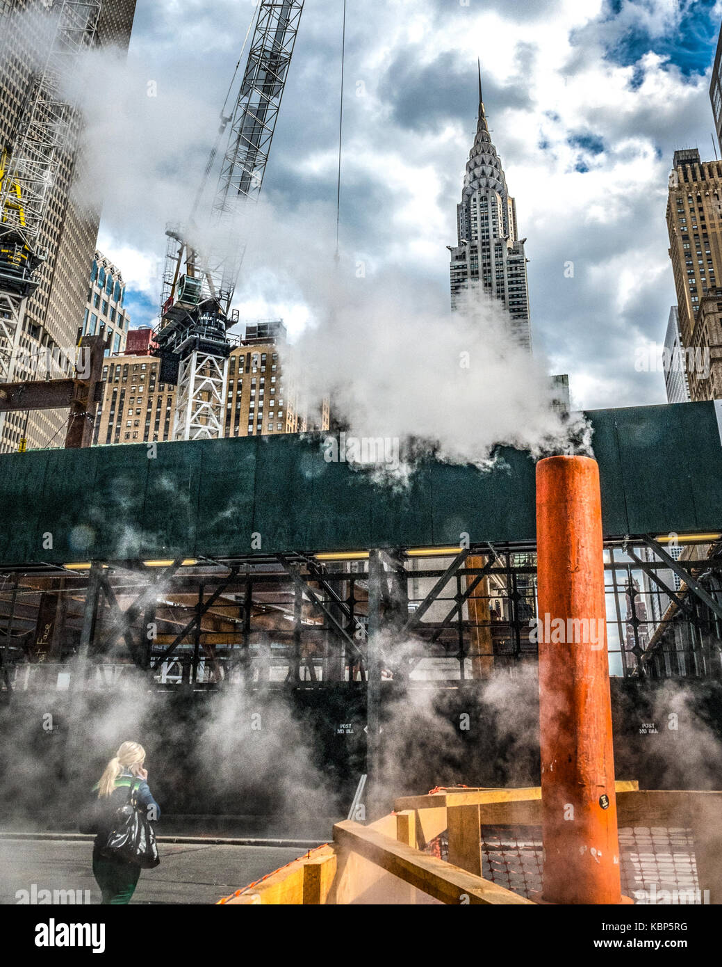 New York, USA,  29 September, 2017. Pedestrians cross the street among vapor fumes in front of Chrysler building in midtown New York City. Photo by En Stock Photo