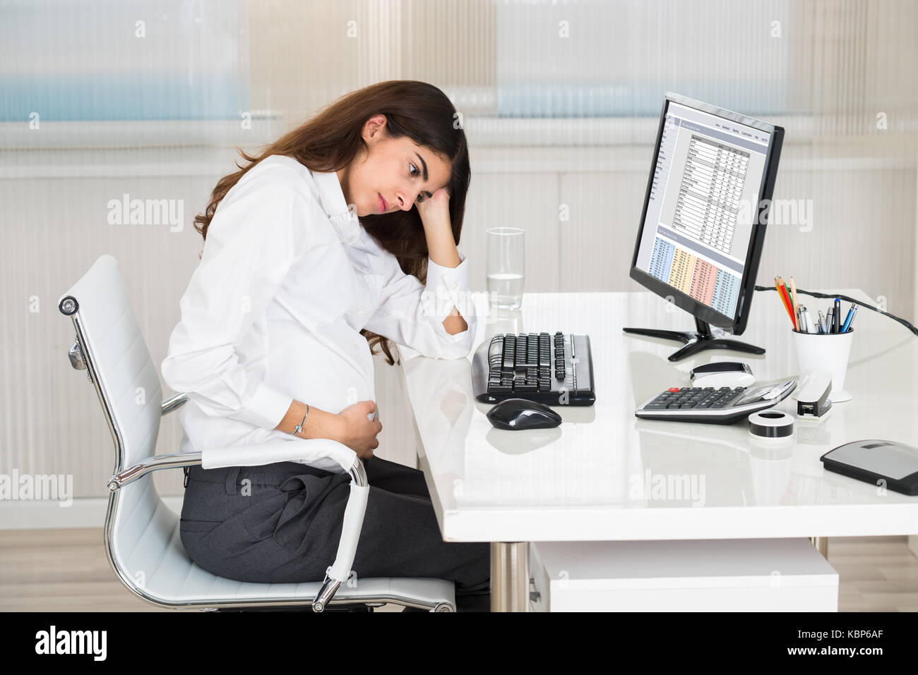 Upset Pregnant Woman Sitting At Computer Desk In Office Stock Photo Alamy