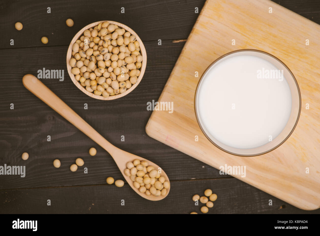 Glass with soy milk and soy bean on wooden background Stock Photo