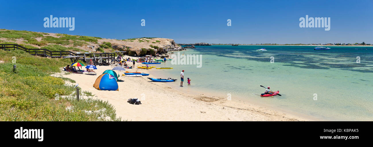 Picnickers and kayakers on a beach on Penguin Island where tourists come to see the penguin colony and other wildlife. Stock Photo