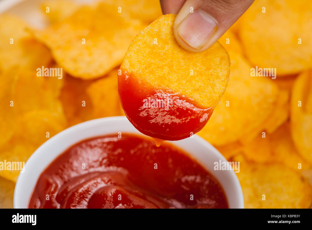 Potato chips and ketchup. Beer snack, unhealthy eating Stock Photo Alamy