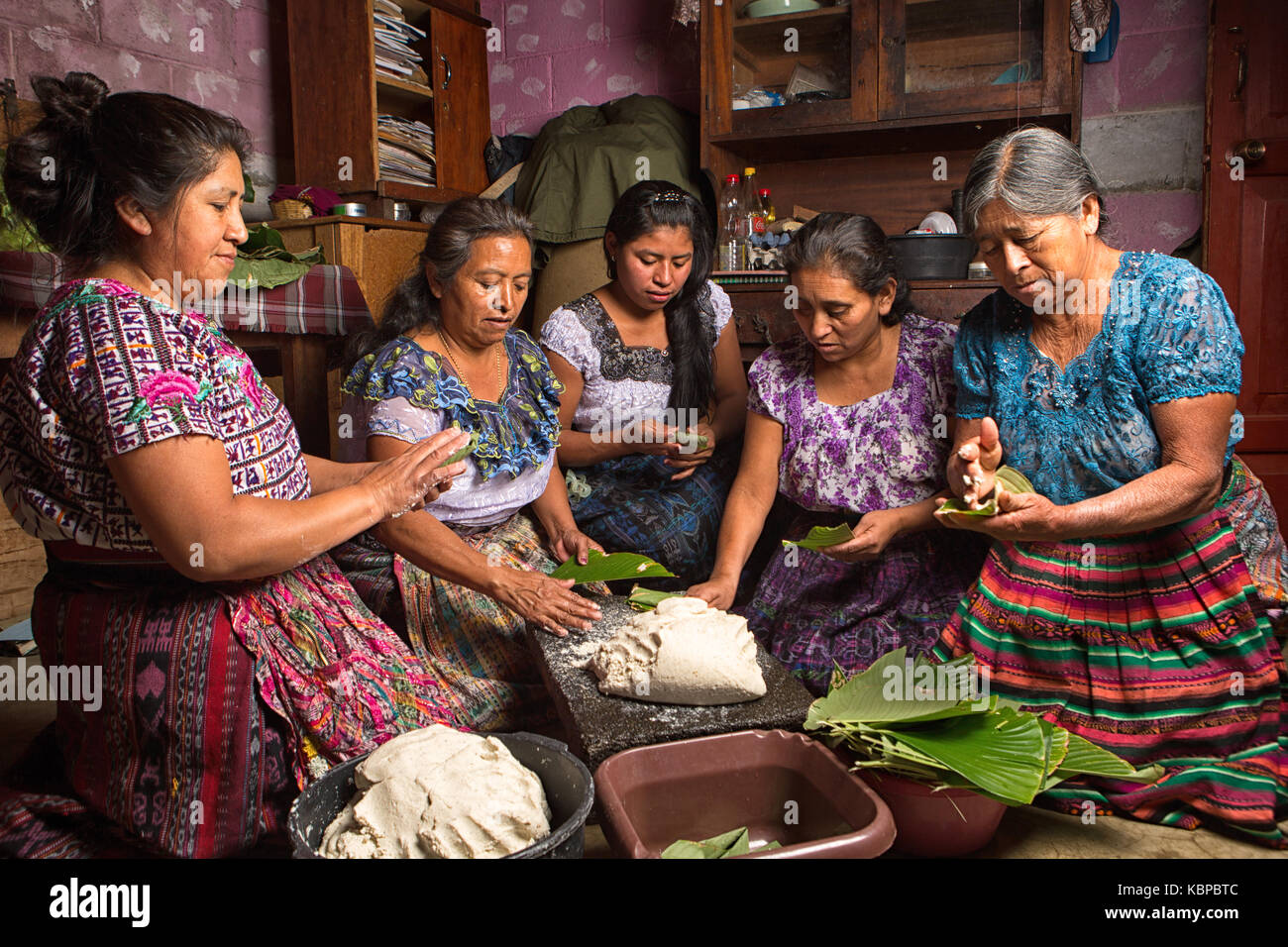 January 20, 2015 San Pedro la Laguna, Guatemala: tzutujil mayan women preparing traditional food together Stock Photo