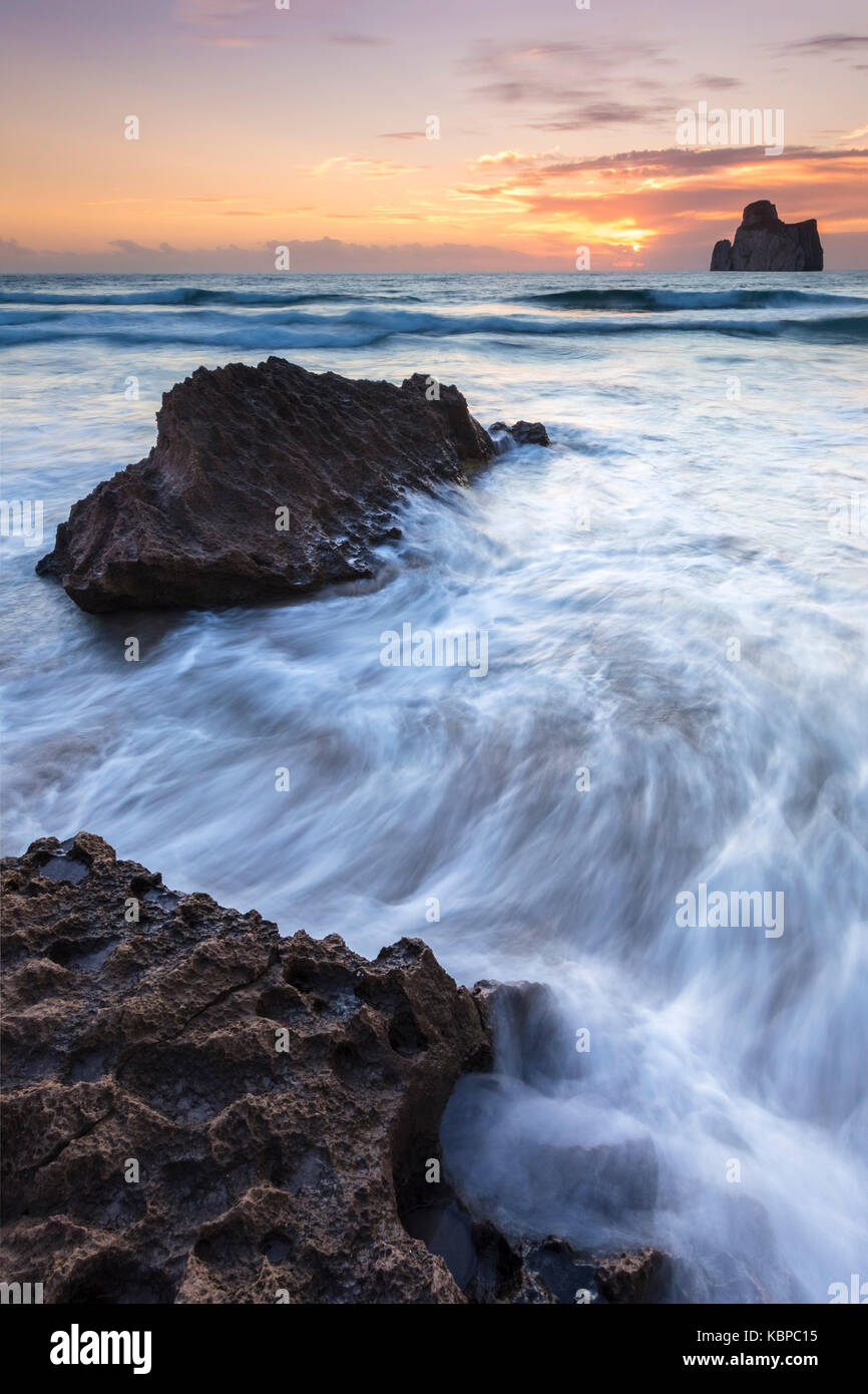 Sunset at Masua beach, in front of the Pan di Zucchero reef. Masua, Sulcis-iglesiente, Iglesias, Sardinia, Italy. Stock Photo