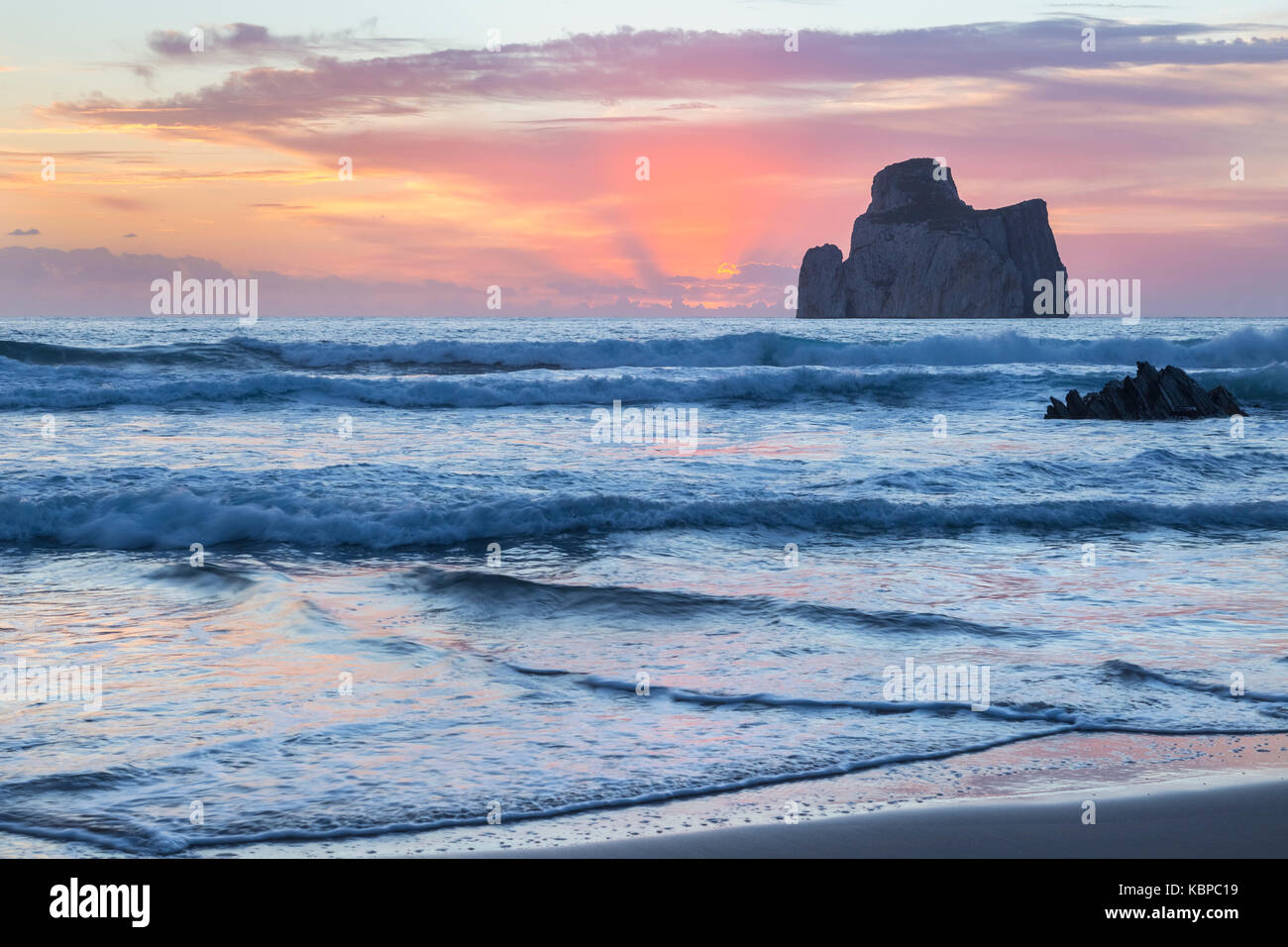 Sunset at Masua beach, in front of the Pan di Zucchero reef. Masua, Sulcis-iglesiente, Iglesias, Sardinia, Italy. Stock Photo