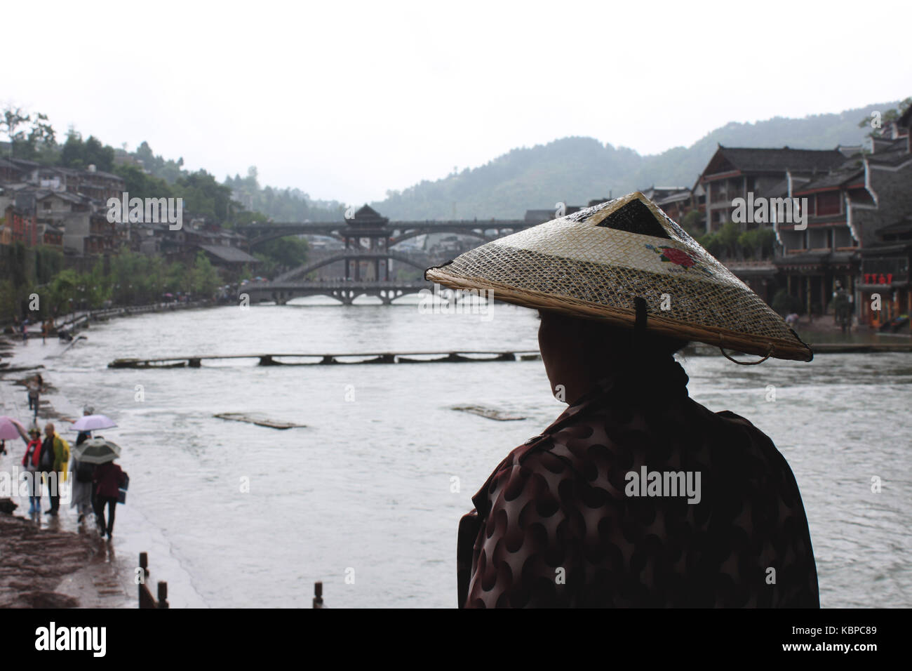 Local Chinese looking at the river in Fenghuang, China Stock Photo