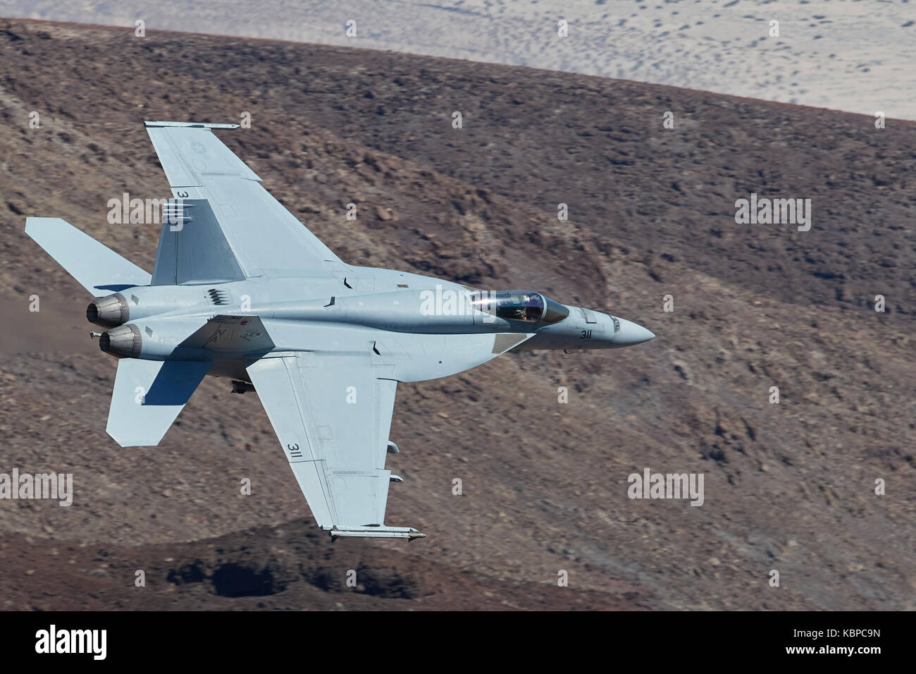 US Navy F/A-18E, Super Hornet, Flying At Low Level Through Rainbow Canyon, California. Stock Photo