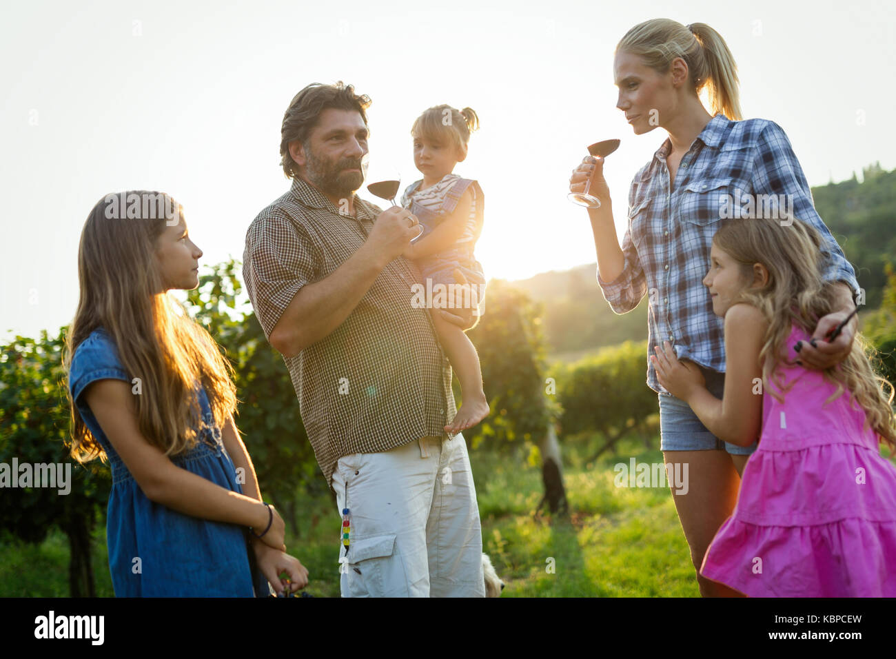 Wine grower family in vineyard before harvesting Stock Photo