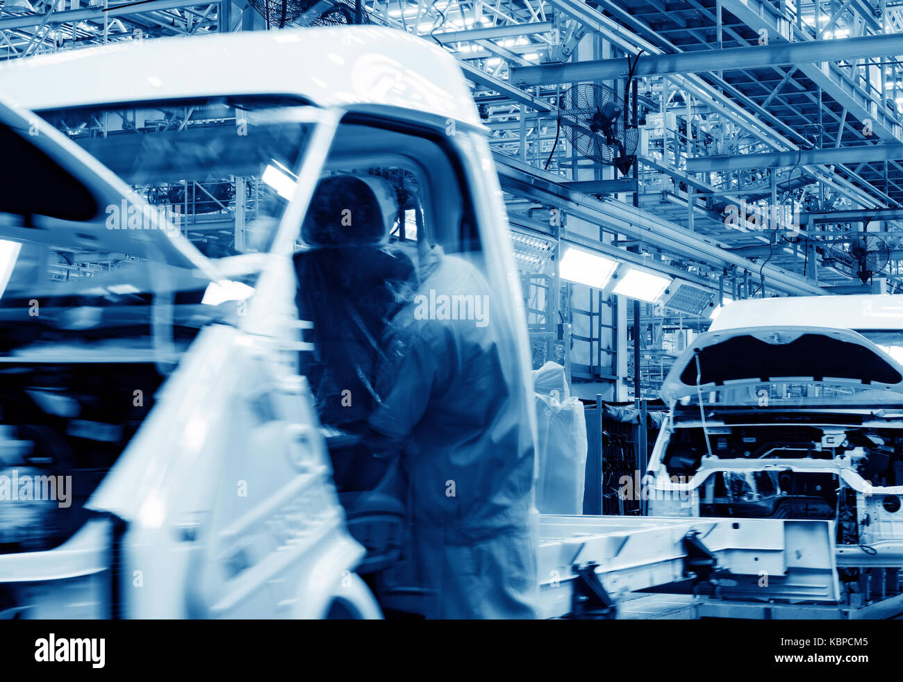 Car production line, skilled workers are working tense. Stock Photo