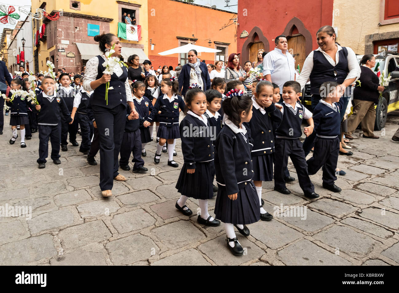 School children hold a procession to the Parroquia de San Miguel Arcangel church during the week long fiesta of the patron saint Saint Michael September 26, 2017 in San Miguel de Allende, Mexico. Stock Photo
