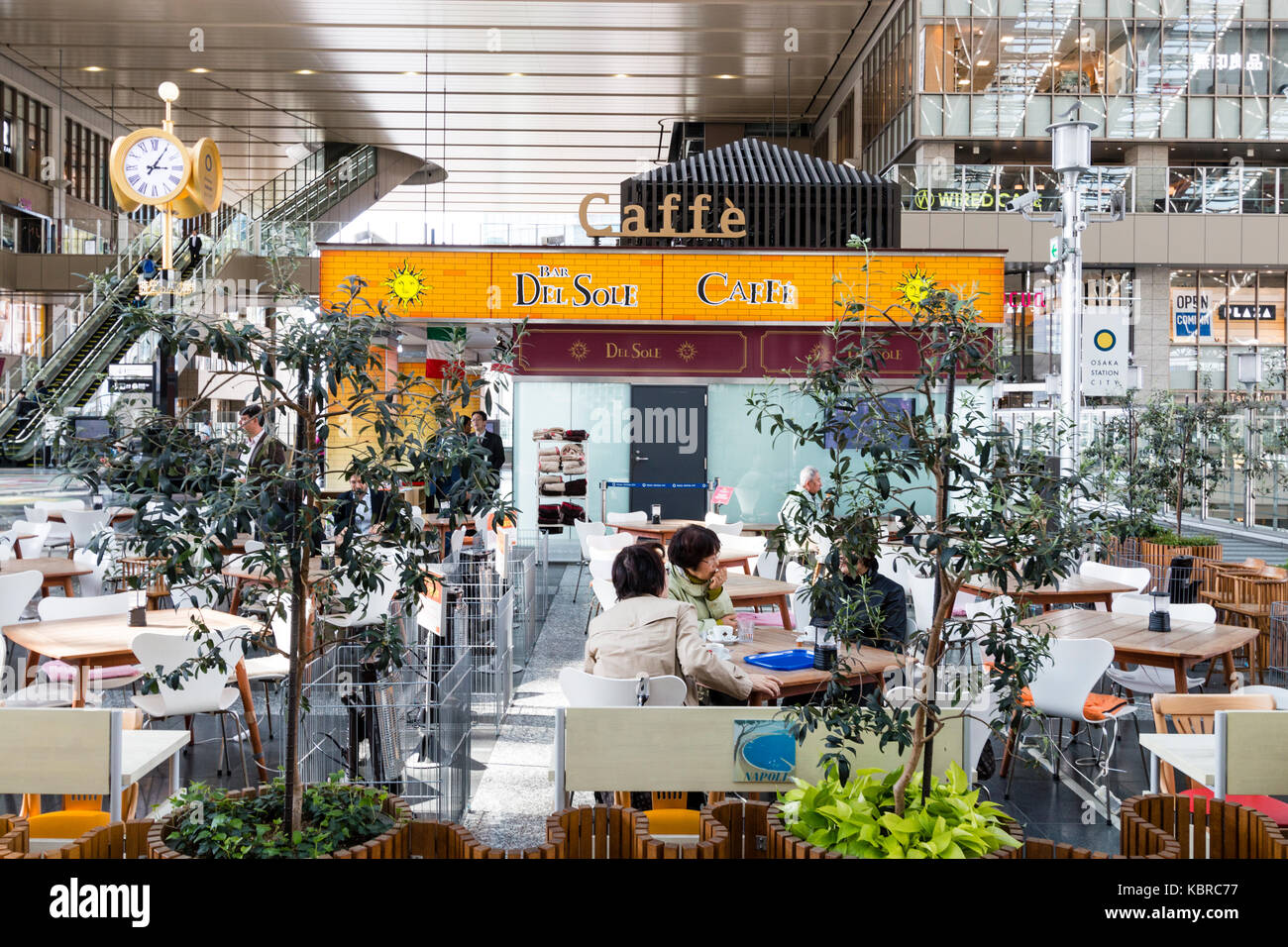 Japan, Osaka, Umeda. Osaka station city, interior, Del Sole cafe bar on main upper concourse. People sitting at tables, drinking and chatting.. Stock Photo