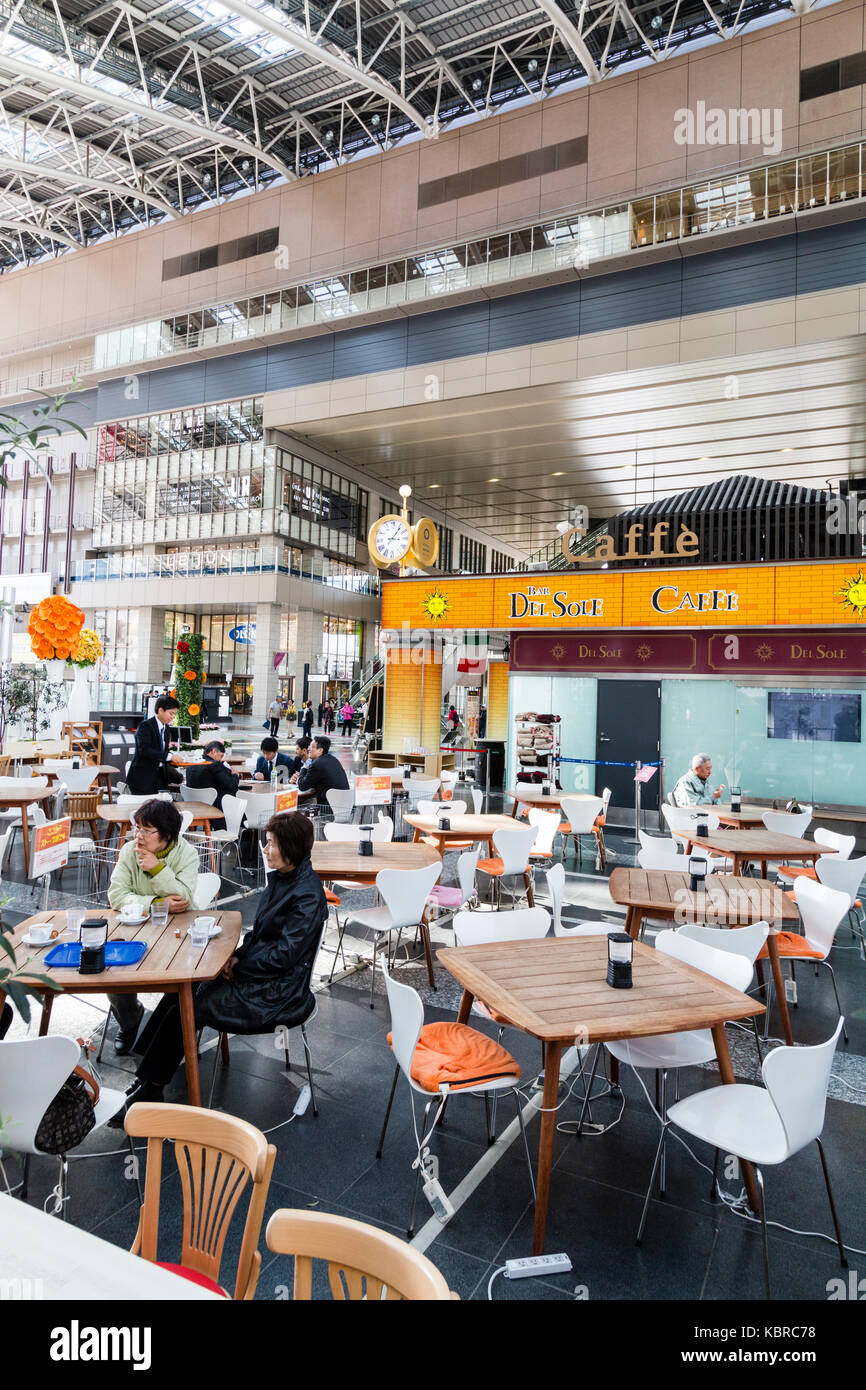 Japan, Osaka, Umeda. Osaka station city, interior, Del Sole cafe bar on main upper concourse. People sitting at tables, drinking and chatting.. Stock Photo