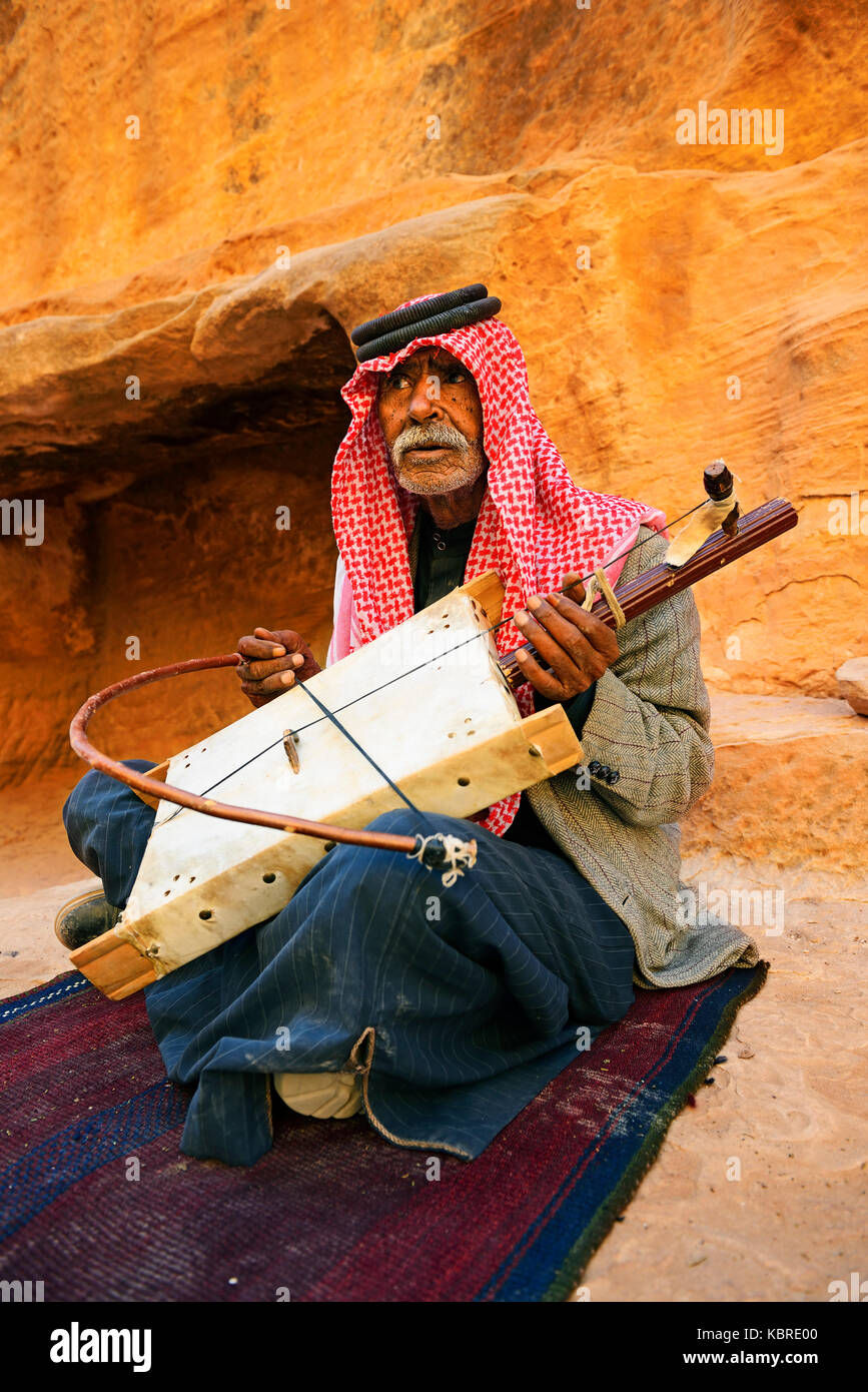 Old bedouin playing the one-string Lyra, Little Petra, Jordan Stock Photo