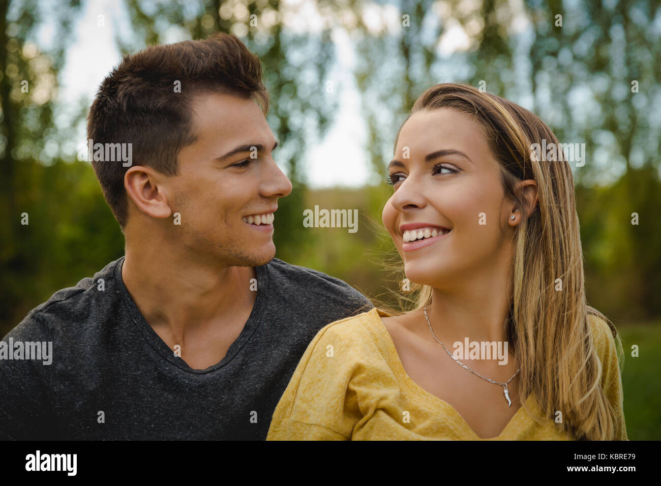 Portrait of a young beautiful couple smiling Stock Photo - Alamy