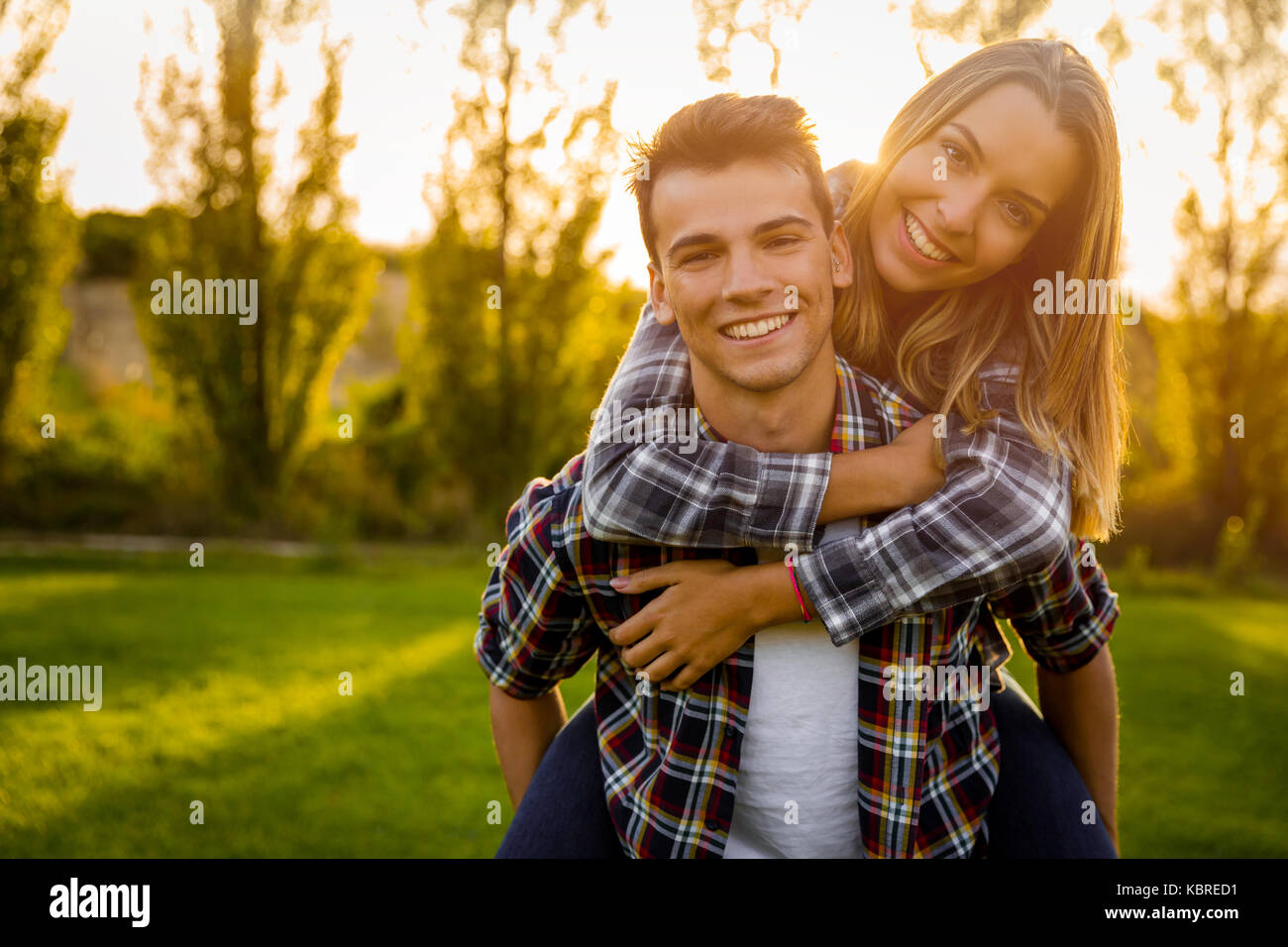Portrait of a happy young couple in the nature hugged together Stock Photo