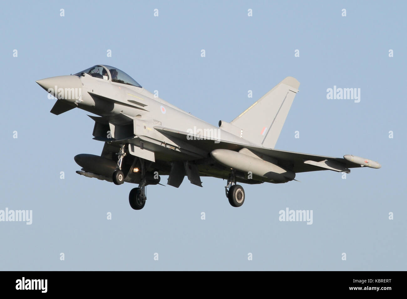 RAF Eurofighter Typhoon landing on runway 25 at RAF Coningsby out of a clear blue sky. Stock Photo