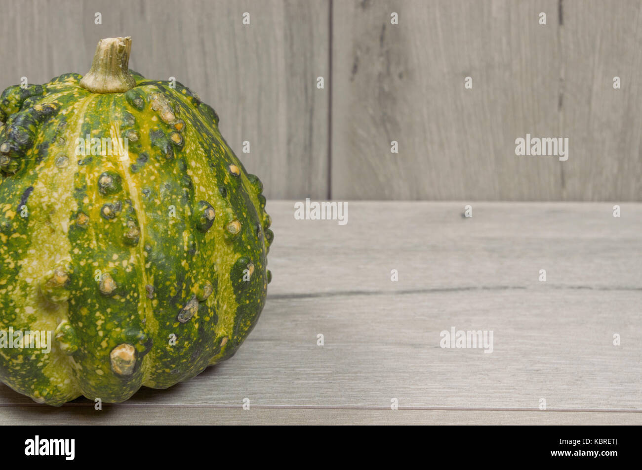 Close up of a decorative gourd on a wood background Stock Photo Alamy
