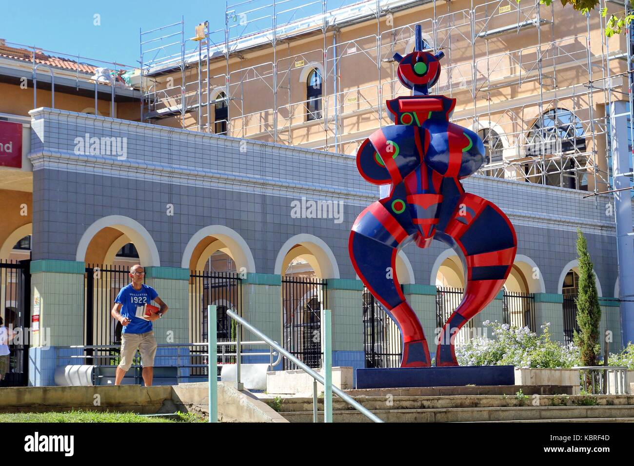 Man with books leaving the Mediatheque (Library) Francois Mitterrand in Sete,  Languedoc, France, next to the statue "Standing Woman" (renovated 2016  Stock Photo - Alamy