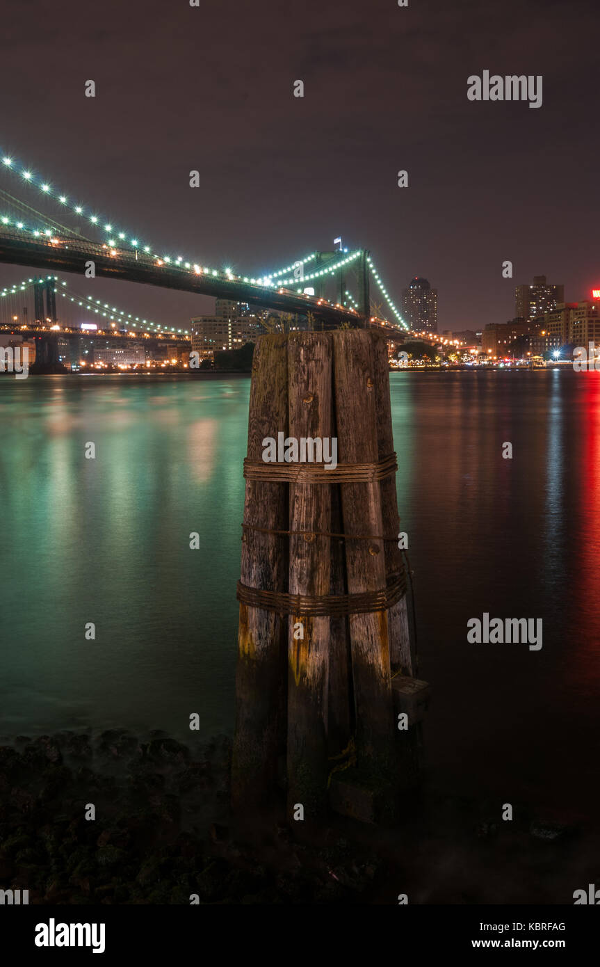Brooklyn Bridge closeup over East River at night in New York City ...