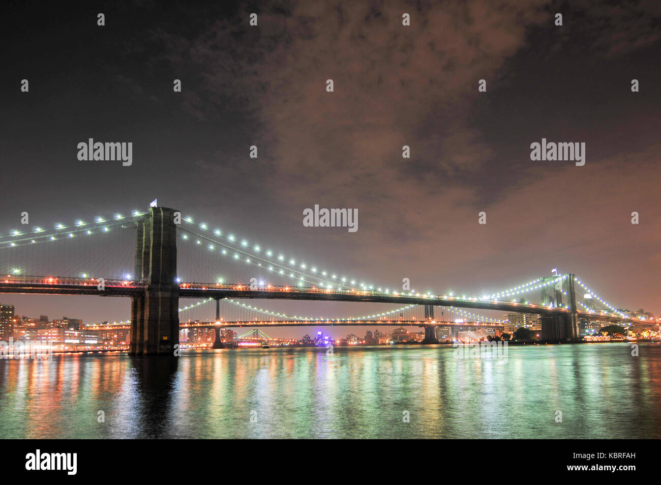 Brooklyn Bridge closeup over East River at night in New York City ...