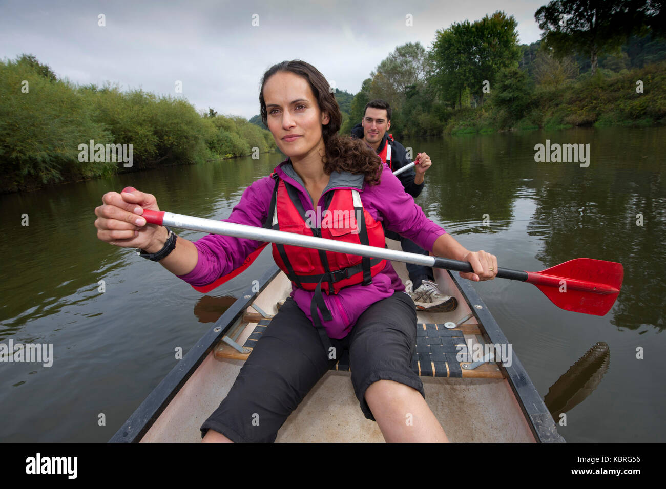 Broadcaster, model, anthropologist Mary-Ann Ochota canoing with her husband Joe Craig on the River Severn with their dog 'Harpo'. Stock Photo