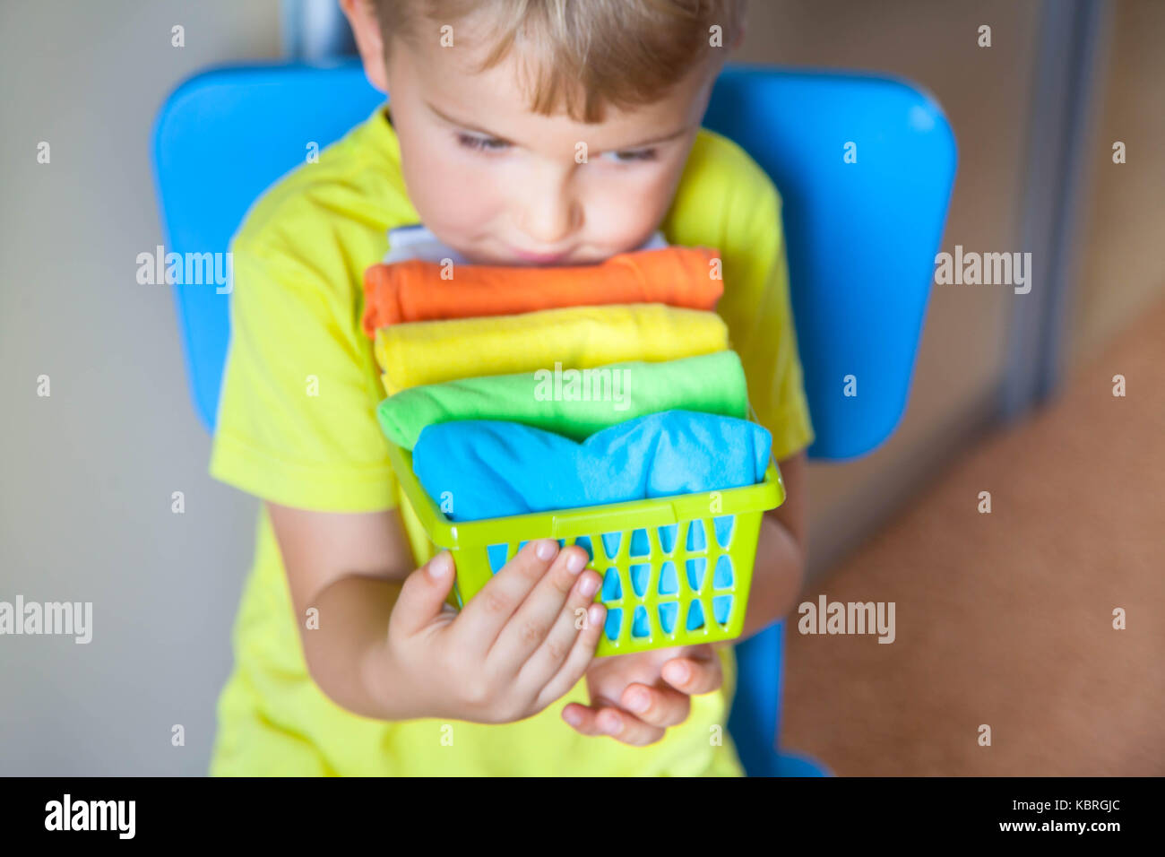 The Child Keeps His Things The Boy Puts The T Shirts In A Drawer