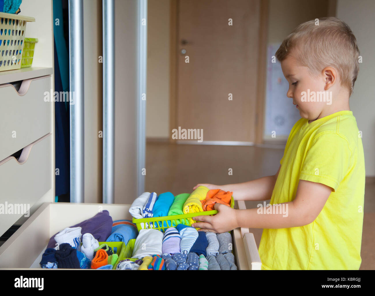 The Child Helps My Mother The Boy Puts The T Shirts In A Drawer