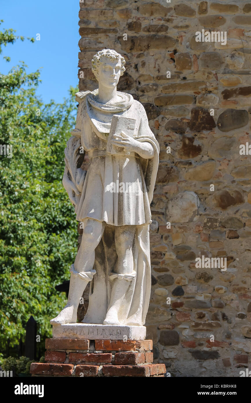 Marble statue of St. Damian at the entrance to the parish of Cosmas and Domian, Grazzano Visconti, Italy Stock Photo