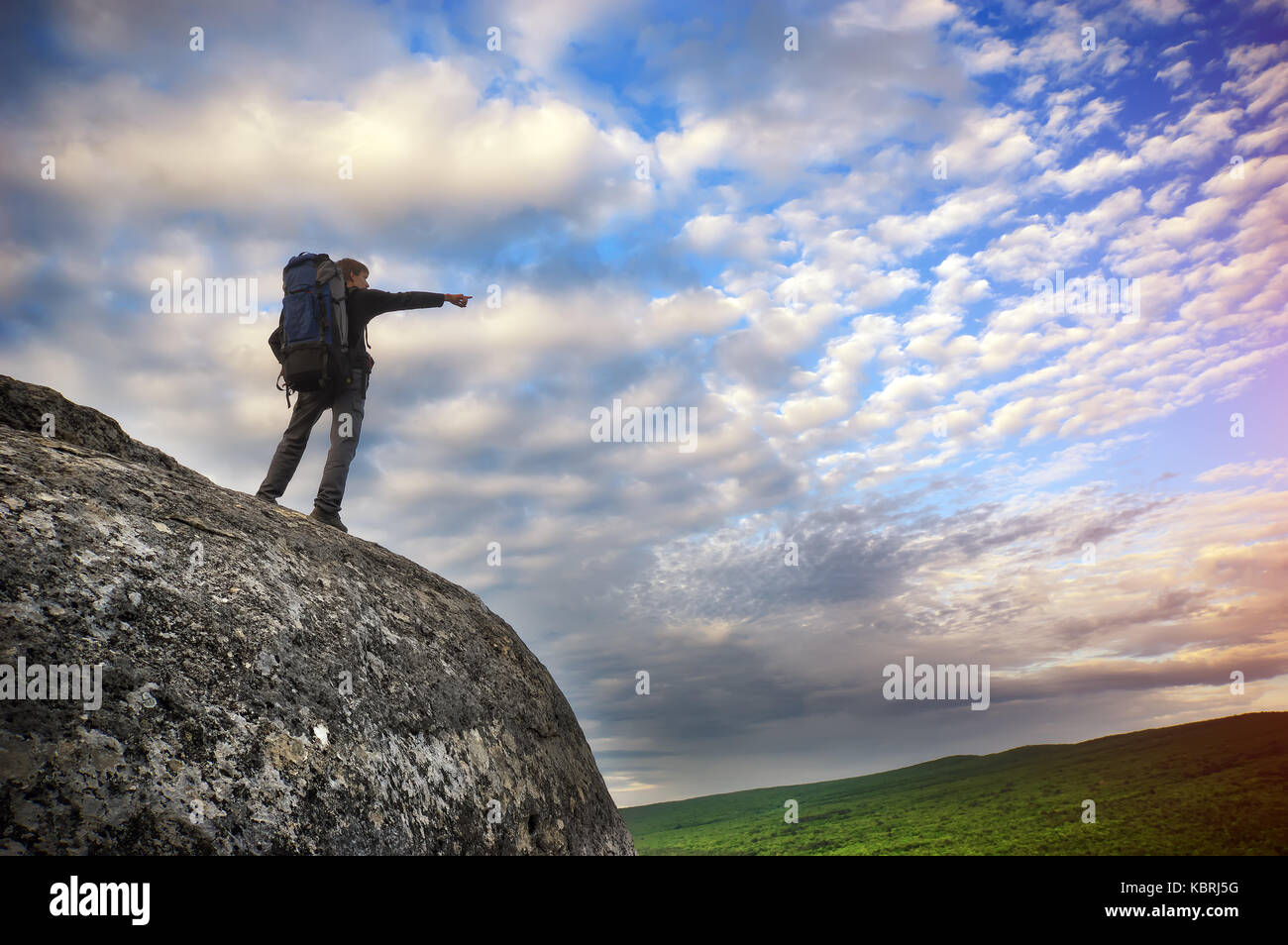 Man on the mountain edge. Conceptual scene. Stock Photo