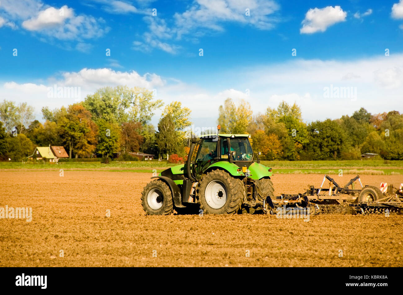 tractor plowing the soil Stock Photo Alamy
