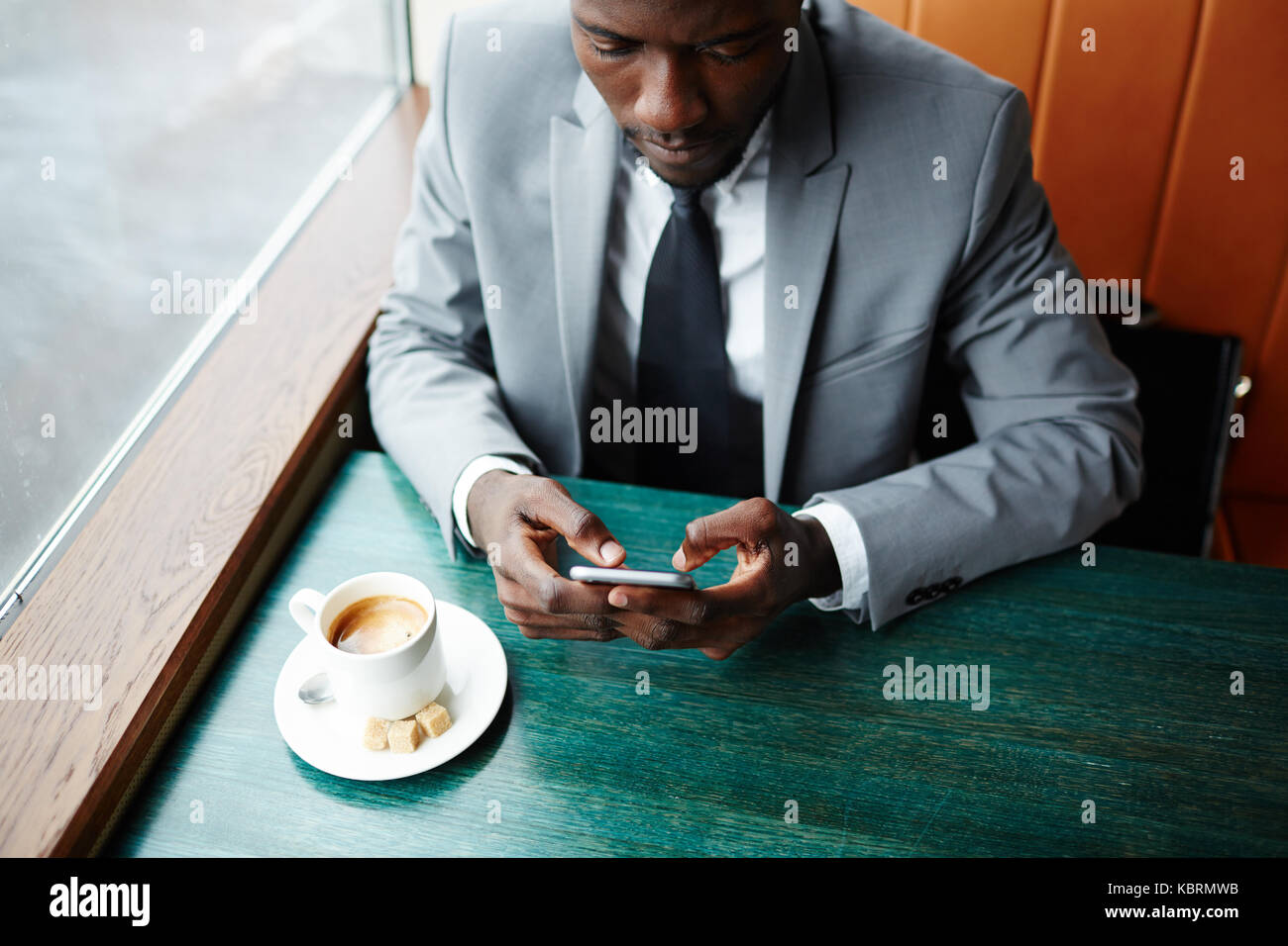 Messaging in cafe Stock Photo