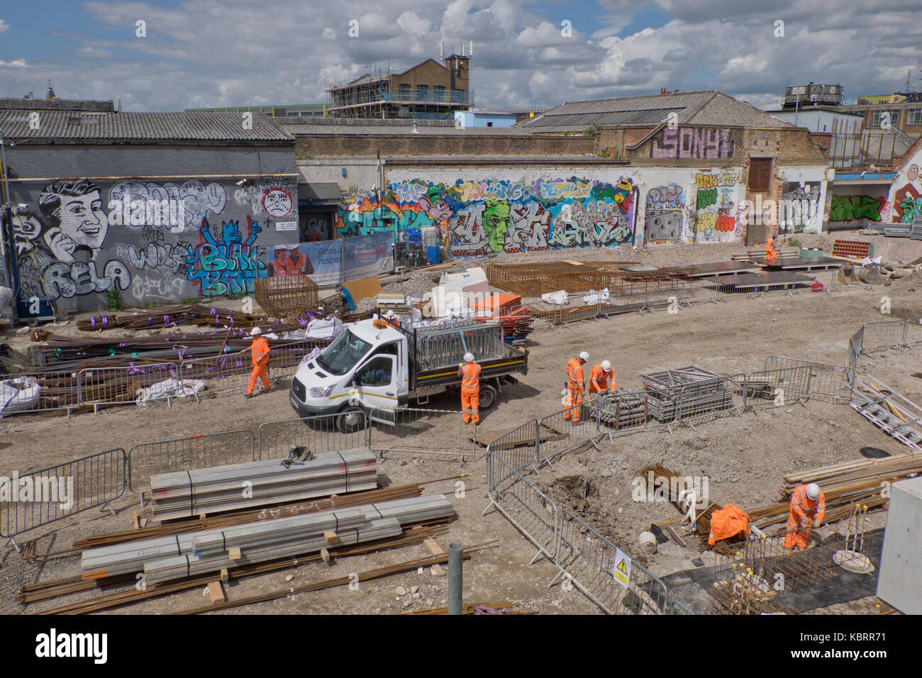 Construction work of new housing blocks with graffiti art in background