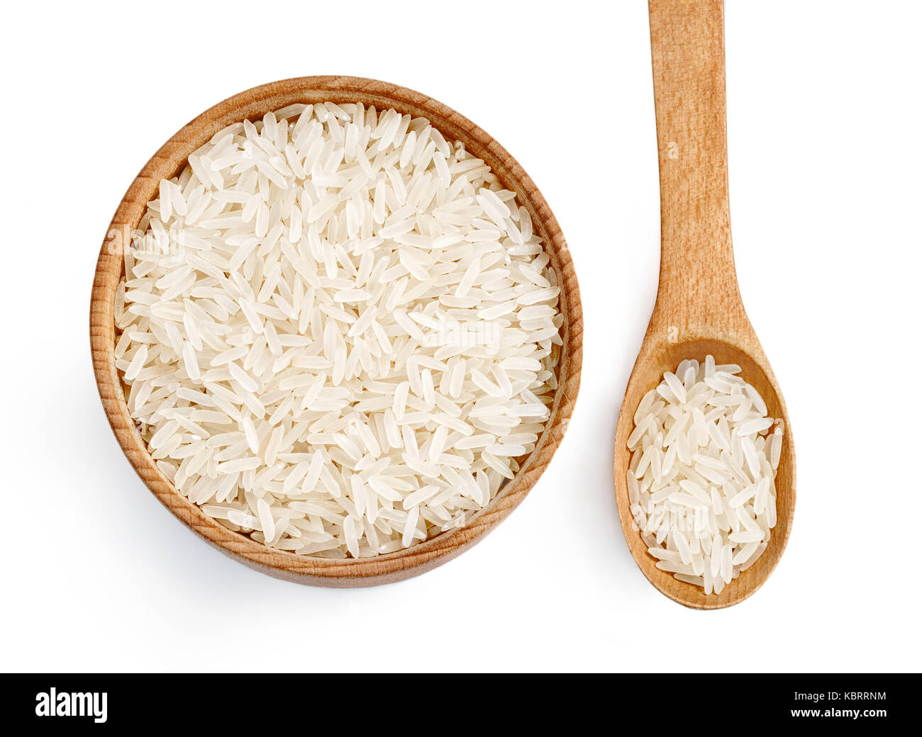 Parboiled rice in wooden bowl and wooden spoon on white background. Healthy food.Top view. High resolution product. Stock Photo