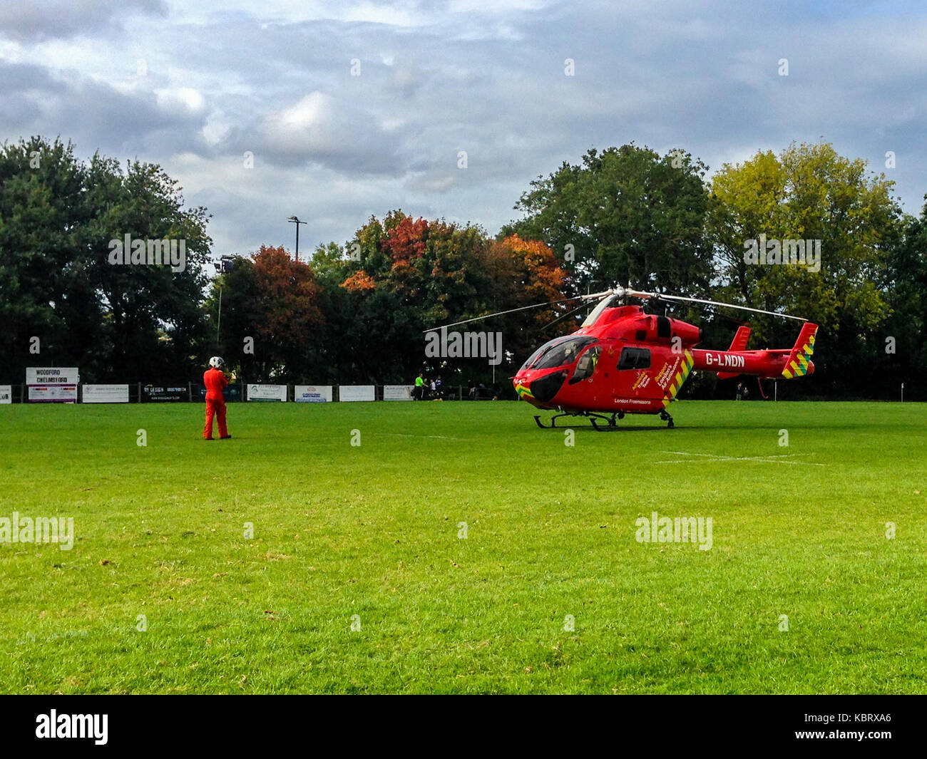 Woodford Green, London, UK. 30th September 2017. London’s  Air Ambulance helicopter G-LNDN lands at Woodford Rugby Football Club's Highams ground in Woodford Green in response to a report of a spectator suffering a heart attack. The Woodford v Chelmsford match was suspended for 40 minutes whilst paramedics attended to the casualty who was able to leave by road.  Woodford went on to win the match. The Air Ambulance is supported by London Freemasons.  Credit: Mark Dunn/ Alamy Live News Stock Photo