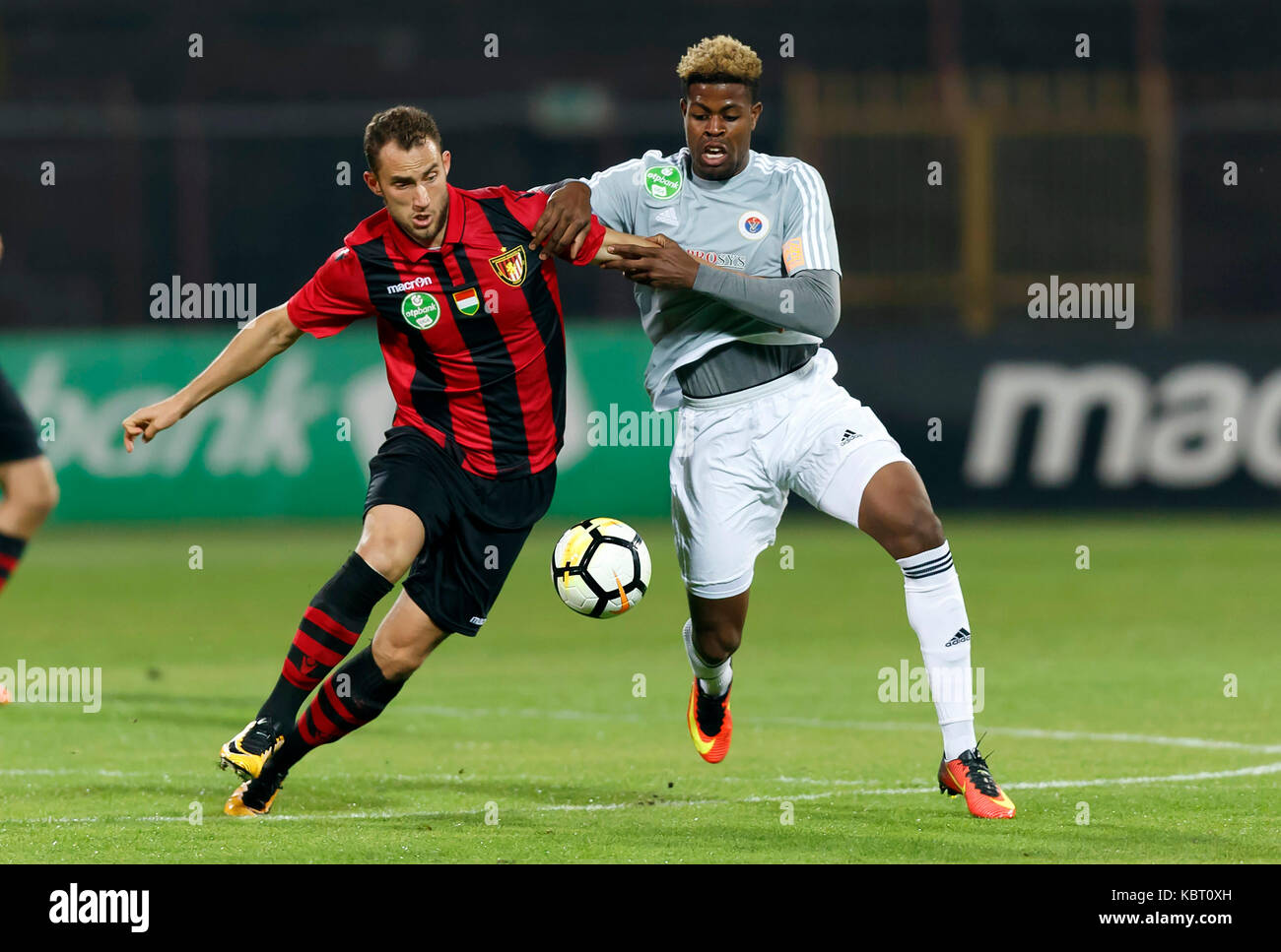 Ivan Petryak of MOL Fehervar FC dribbles between Franck Boli of