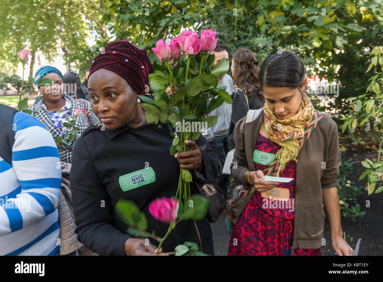 London, UK. 30th September, 2017. Protesters with flowers on the MIgrants Welcome bloc, one of several groups of protesters marching from different starting points to converge on St Thomas' Hospital to call for an end to immigration checks and charging of migrants for NHS services. The Migrants Welcome bloc, Maternity Care bloc and Sisters bloc met opposite the hospital and marched onto the area around the memorial to Jamaican -born Crimean War nurse Mary Seacole for a rally at which a number of testimonies of those who have suffered from these policies were read out. Credit: Peter Marshall/Al Stock Photo