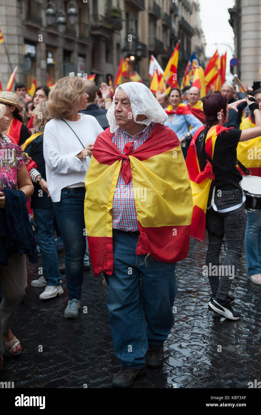 An anti Referendum man covered in a Spanish flag.  Thousands of anti referendum protester took to the streets of Barcelona to express their anger over the referendum of Catalonia independence which set to take place on 1st of October. Stock Photo