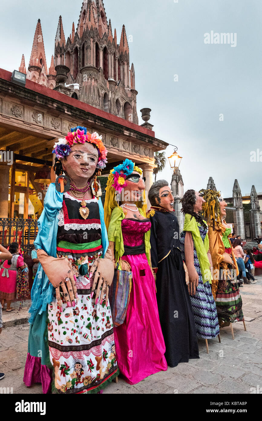 Giant paper-mache puppets called mojigangas line up for a parade during the week long fiesta of the patron saint Saint Michael September 26, 2017 in San Miguel de Allende, Mexico. Stock Photo