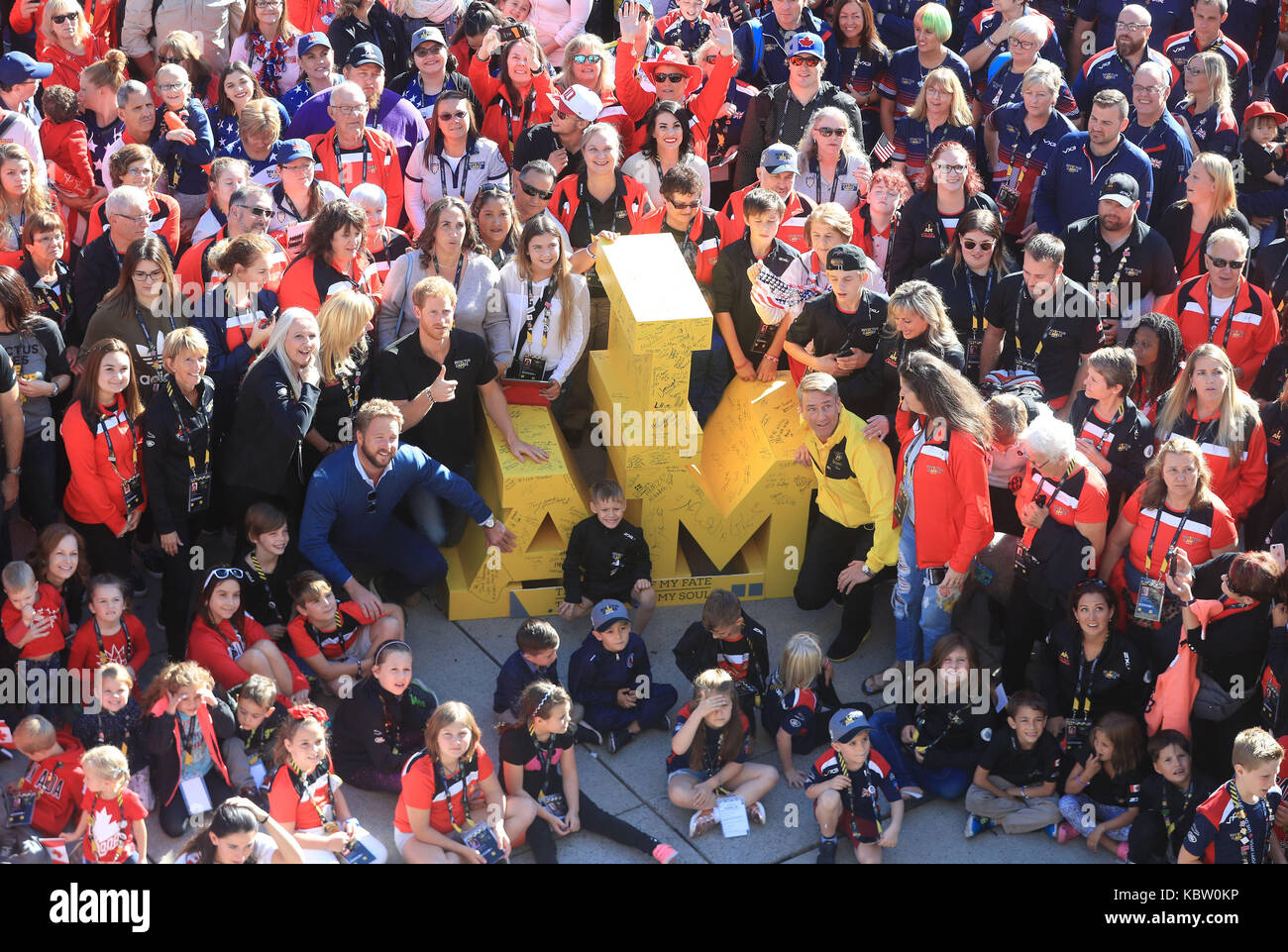 Prince Harry (centre left) with competitors friend and families in Nathan Philips Square at the Invictus Games in Toronto, Canada. Stock Photo