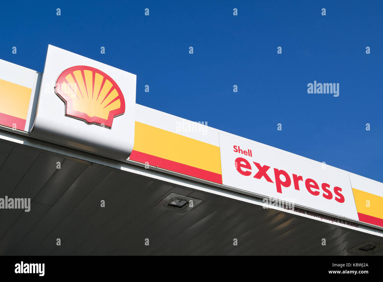 Shell sign against blue sky. Shell is an Anglo-Dutch multinational oil and gas company headquartered in the Netherlands and incorporated in the UK. Stock Photo
