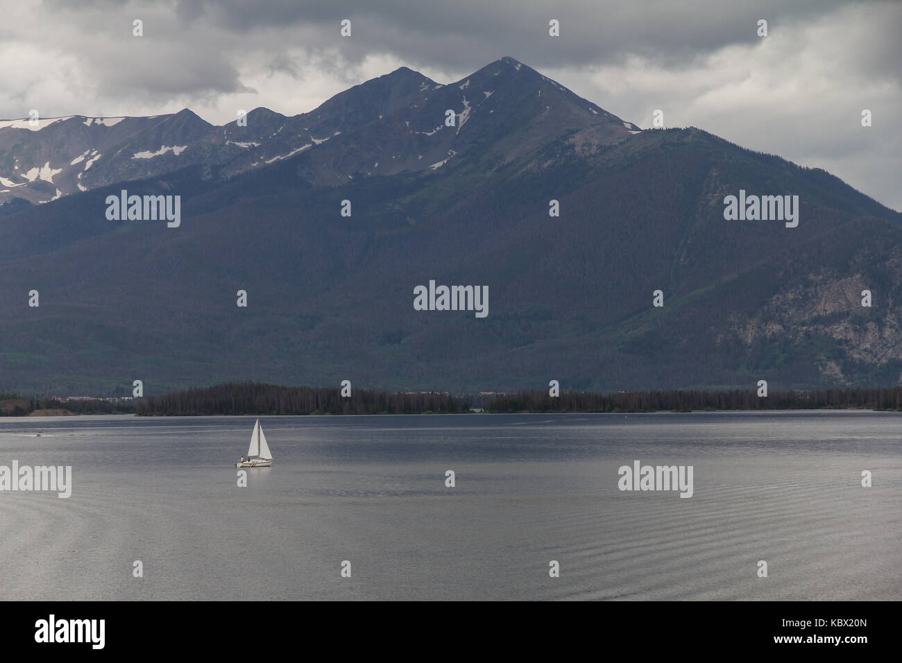 Single sailboat on a stormy day at Lake Dillon, Colorado.  Mount Royal is in the background.  Colorado, USA. Stock Photo