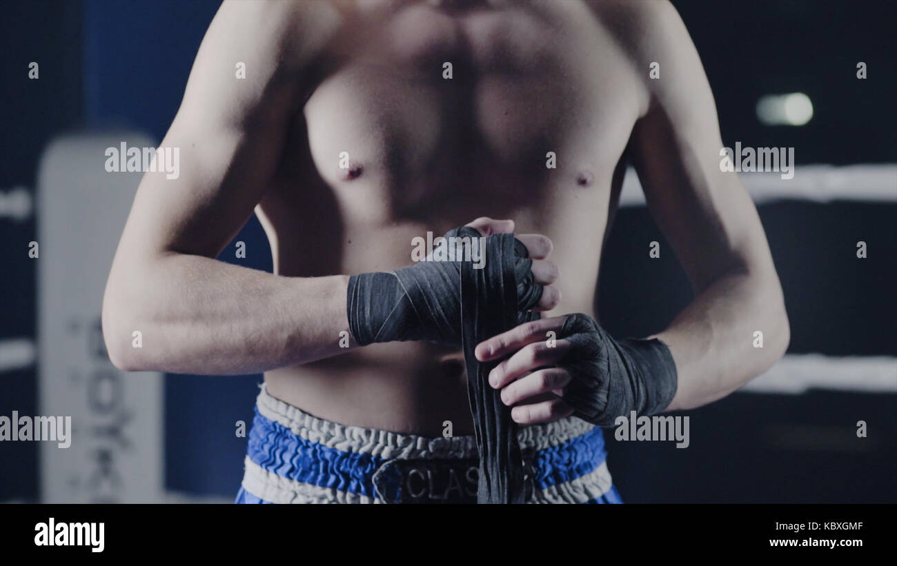 Closeup of a mixed martial arts fighter wrapping his hands before a
