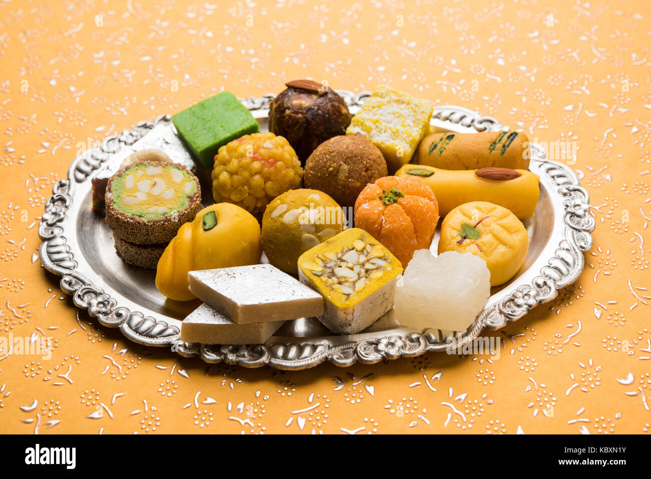 Stock photo of Indian sweets served in silver or wooden plate. variety ...