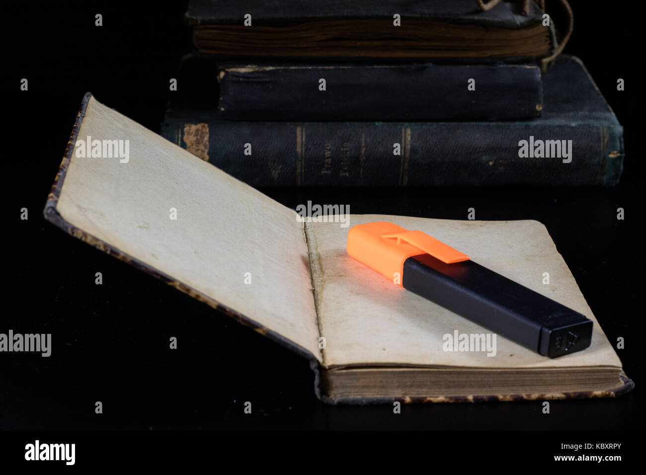 https://c8.alamy.com/comp/KBXRPY/old-book-lying-on-a-black-countertop-and-office-marker-black-background-KBXRPY.jpg