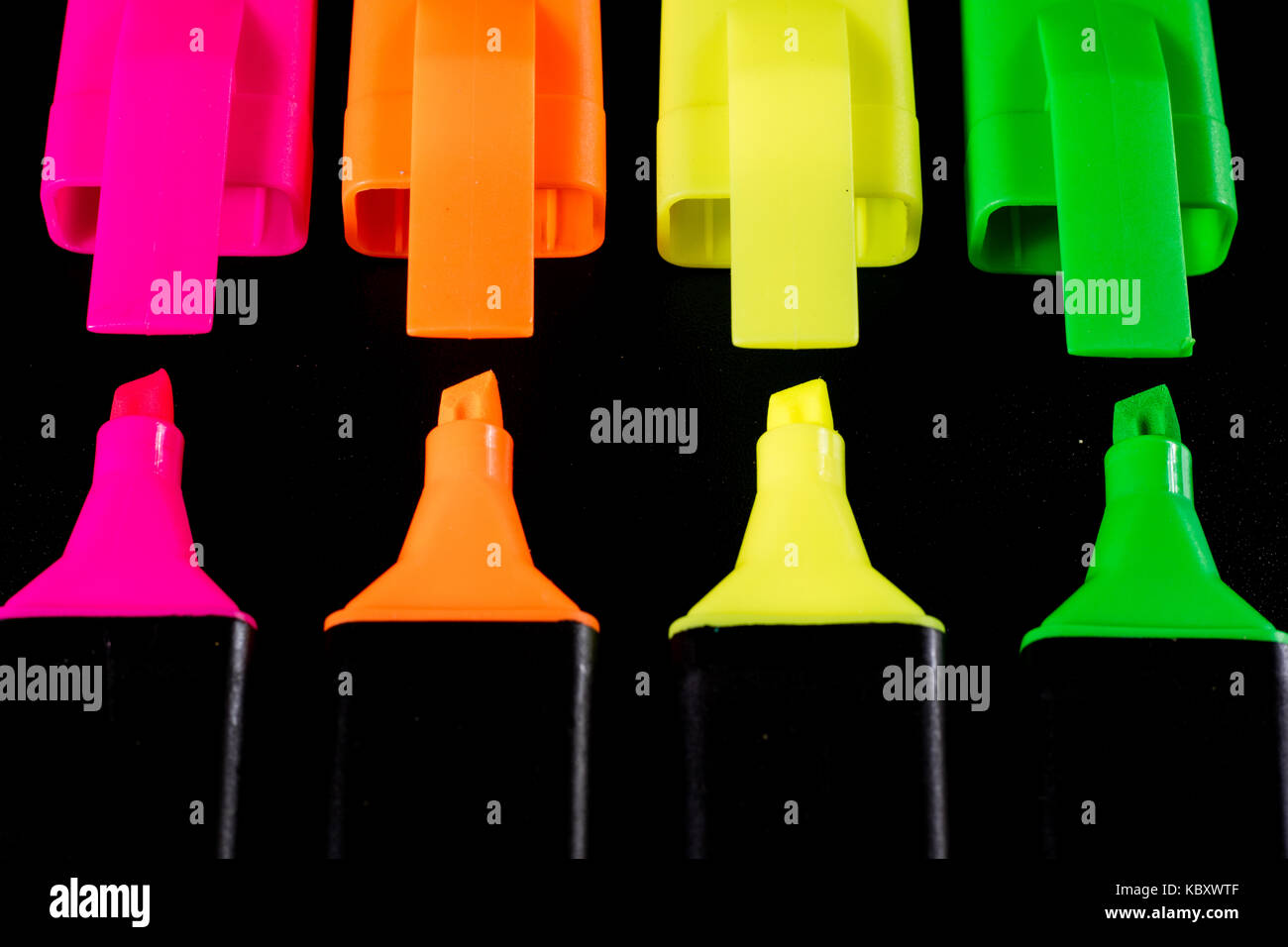 Office Highlighter on a black background. Office Mazak to draw are lying on a black countertop. Black background. Stock Photo