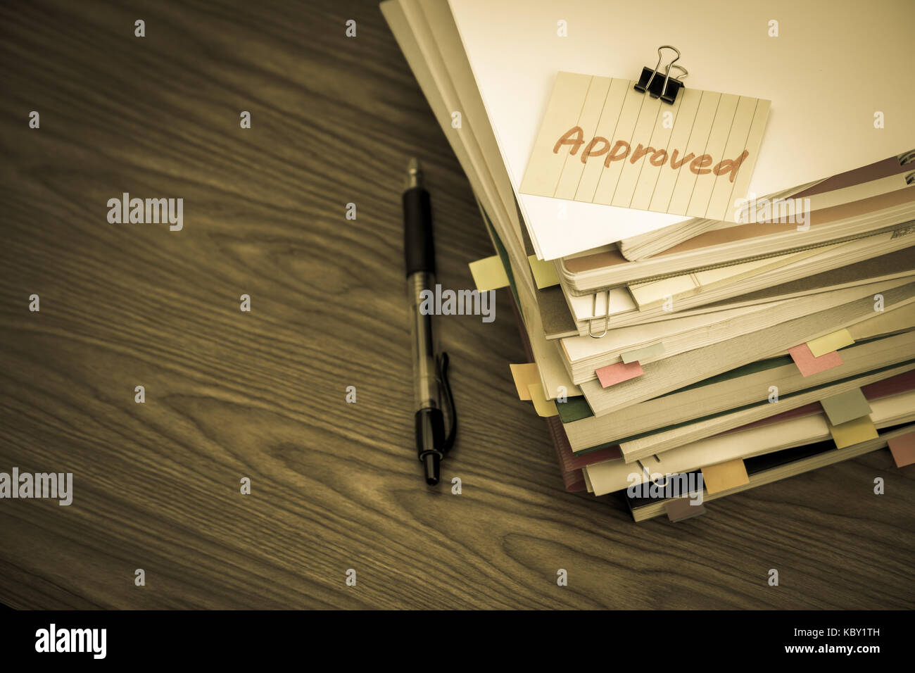 Approved; The Pile of Business Documents on the Desk Stock Photo