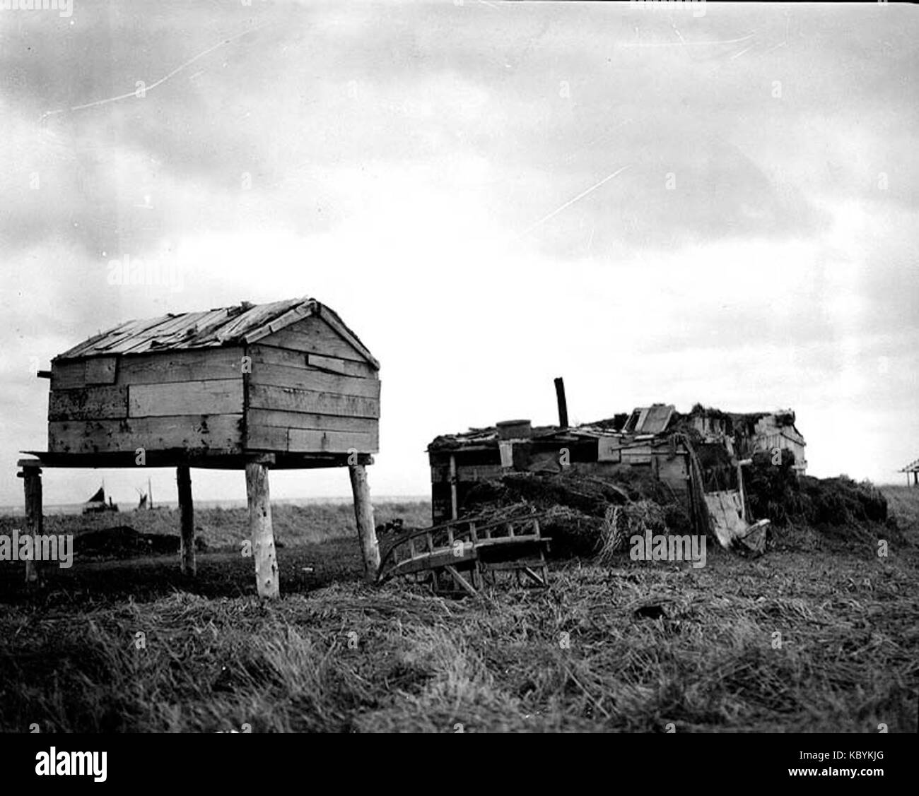 Eskimo barabara, or sod hut, and food cache, Nushagak, Alaska, 1917 ...