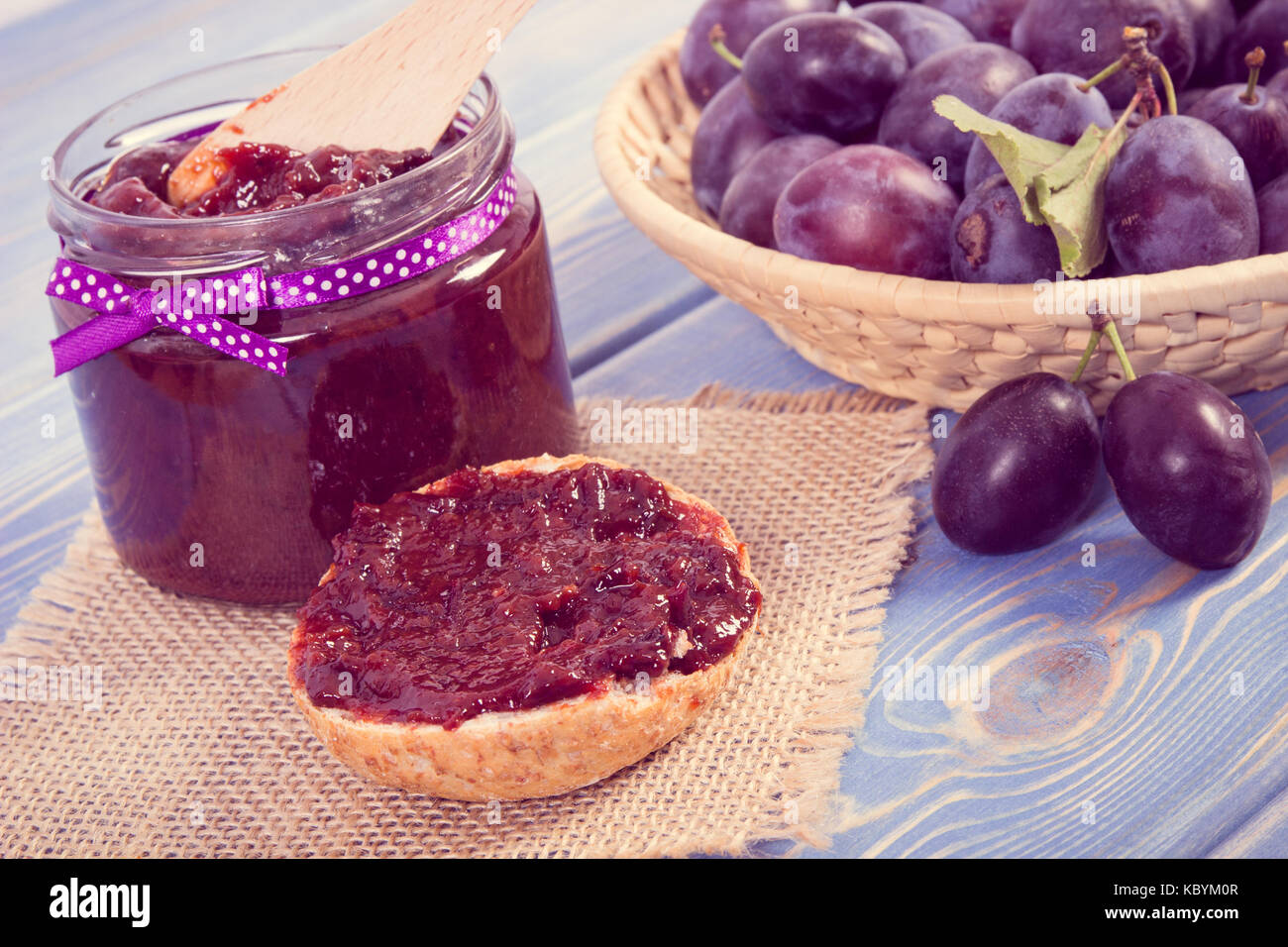 Preparation fresh sandwiches with homemade plum marmalade or jam, concept of healthy sweet snack, breakfast or dessert Stock Photo