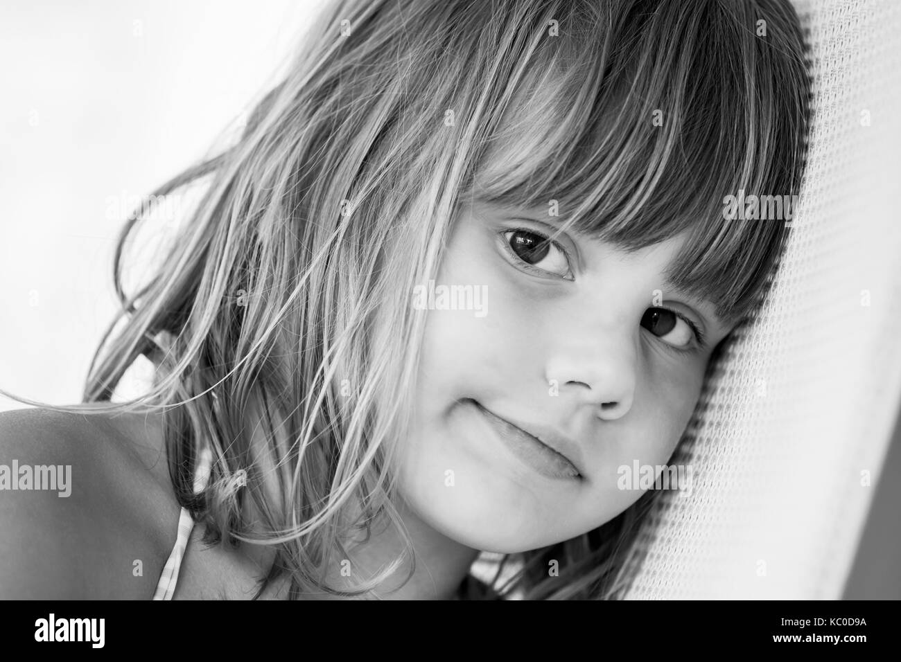 Cute Caucasian little girl, black and white close-up face portrait Stock Photo